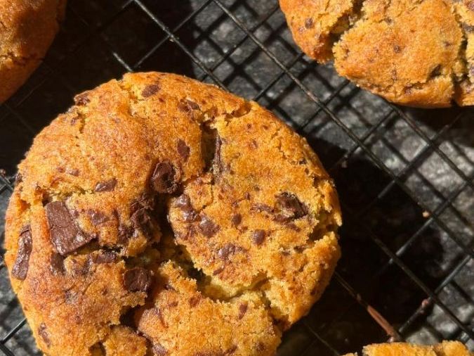 Choco chip cookies cooling on a rack, chocolate chunks visible